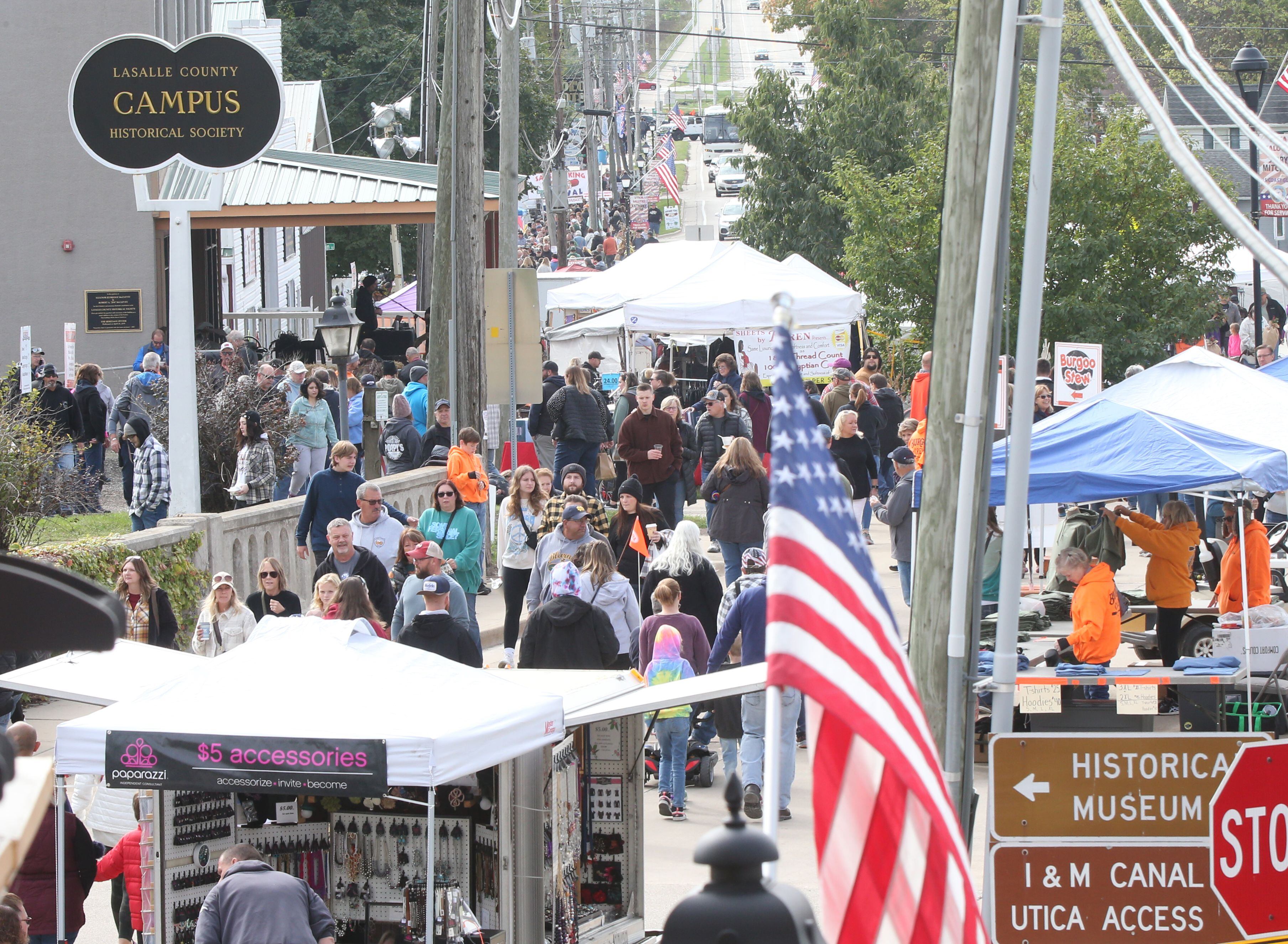 People walk down Mill Street for the 53rd annual Burgoo on Sunday, Oct. 8, 2023 downtown Utica.