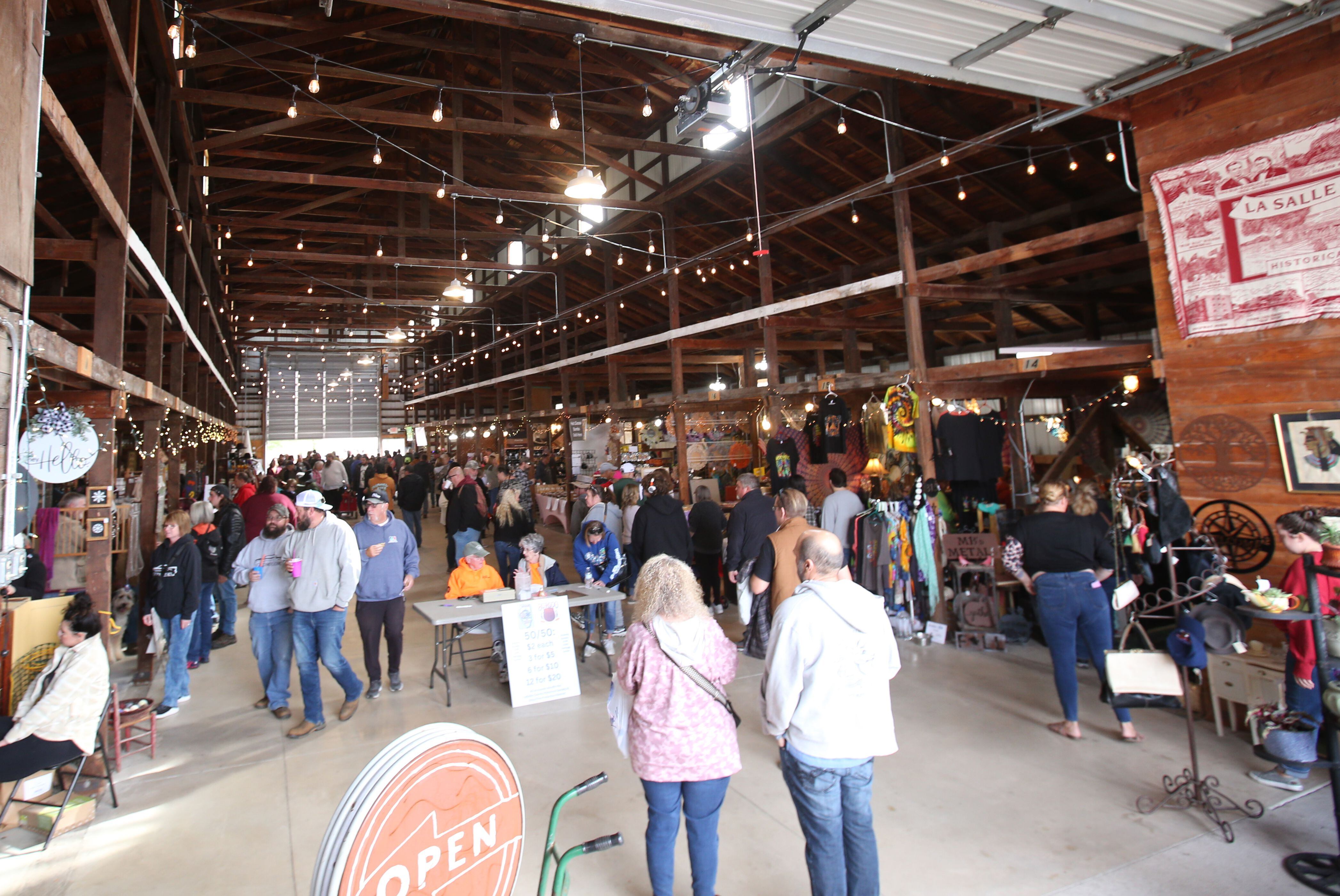 People walk through the Canal Market building during the 53rd annual Burgoo on Sunday, Oct. 8, 2023 downtown Utica.