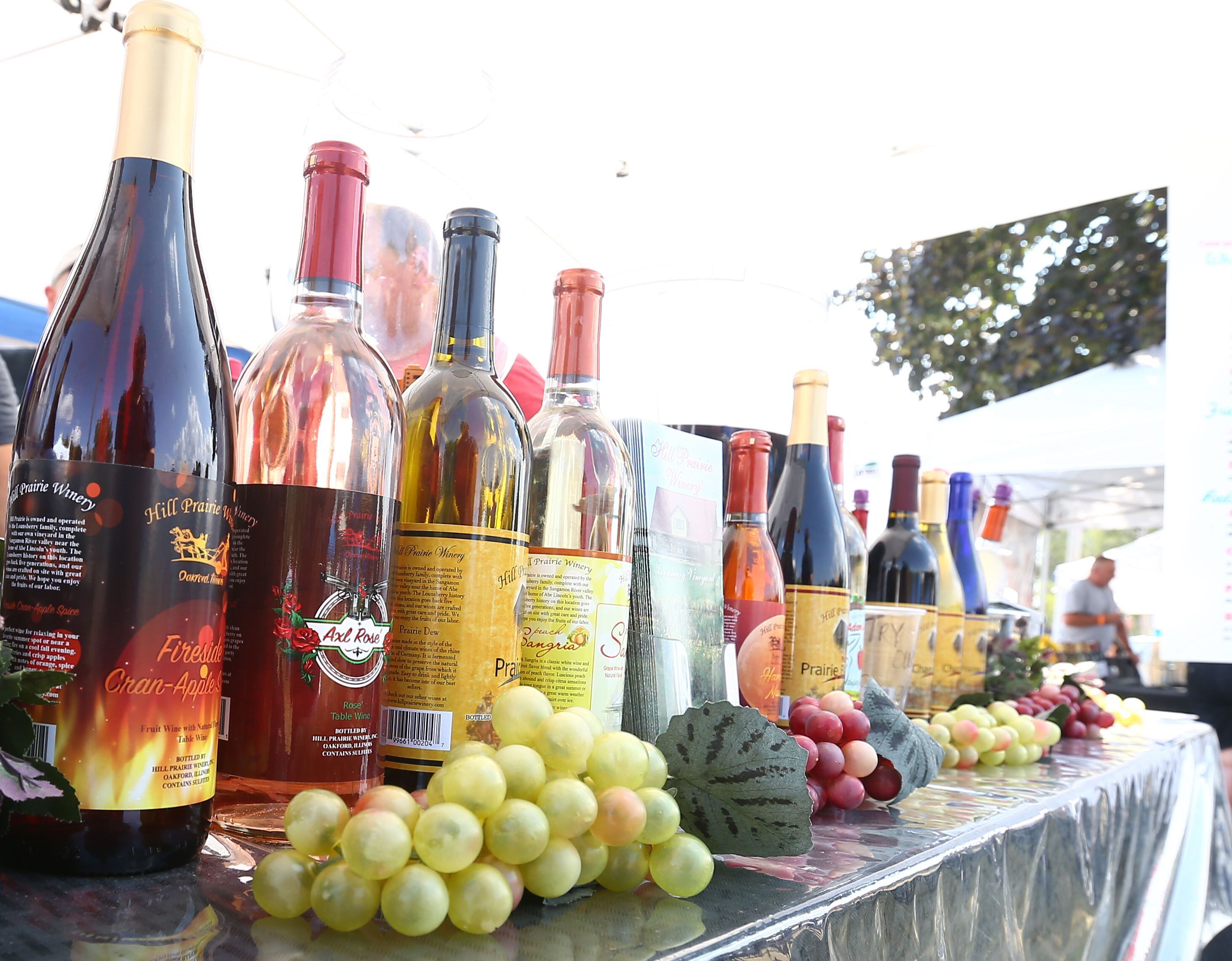A display of wine bottles and grapes welcome visitors at the Illinois Vintage Wine Fest in Utica.