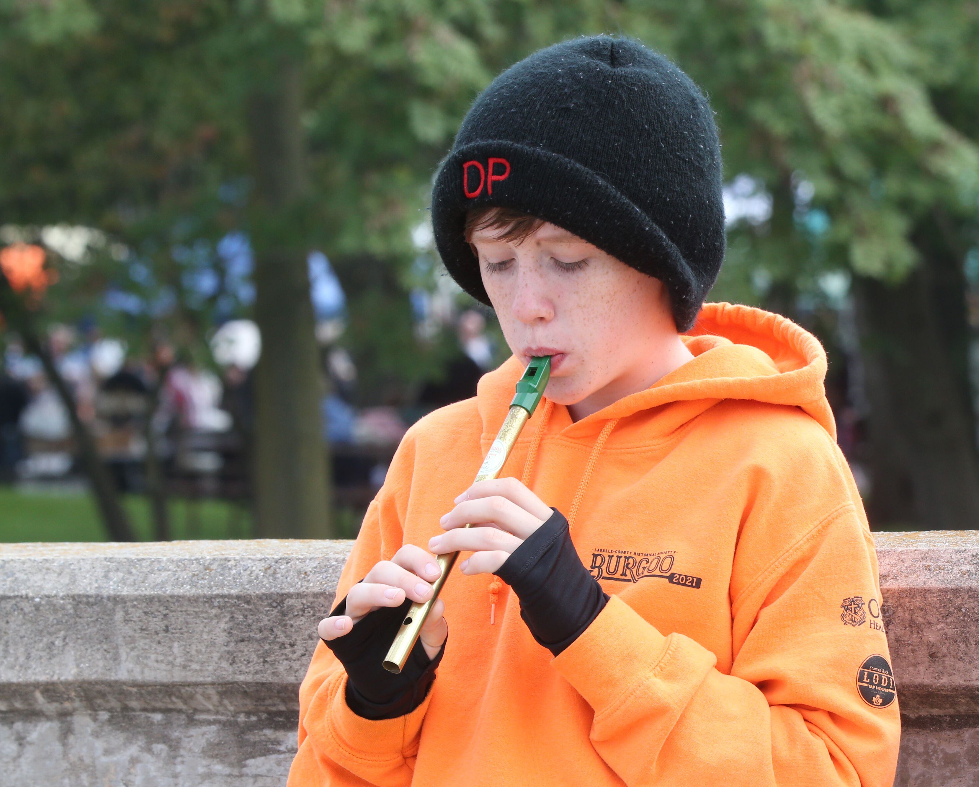 Dane Passwater of Ottawa, playes a Irish tin whistle over the Illinois Michigan canal bridge on Mill Street during the 53rd annual Burgoo on Sunday, Oct. 8, 2023 downtown Utica.
