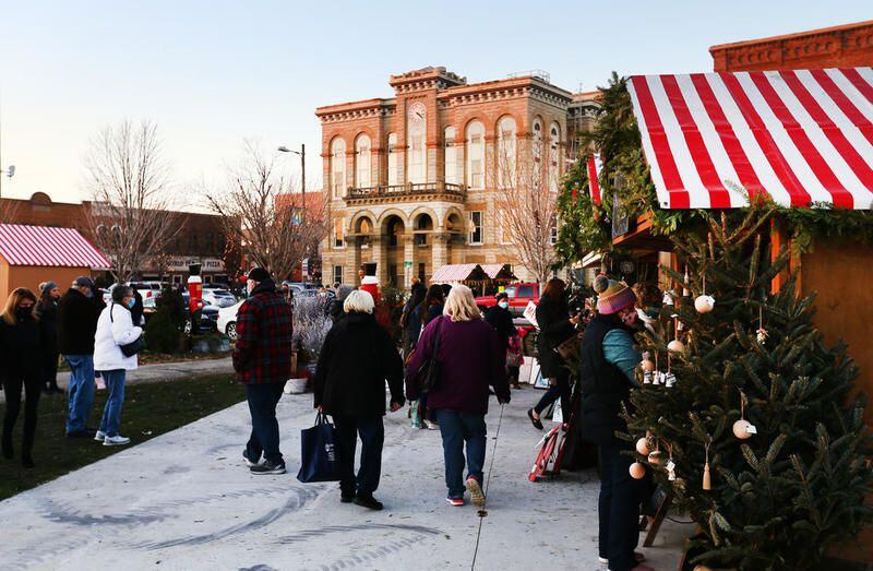 Patrons walk to different huts at the Chris Kringle Market in downtown Ottawa on Friday.