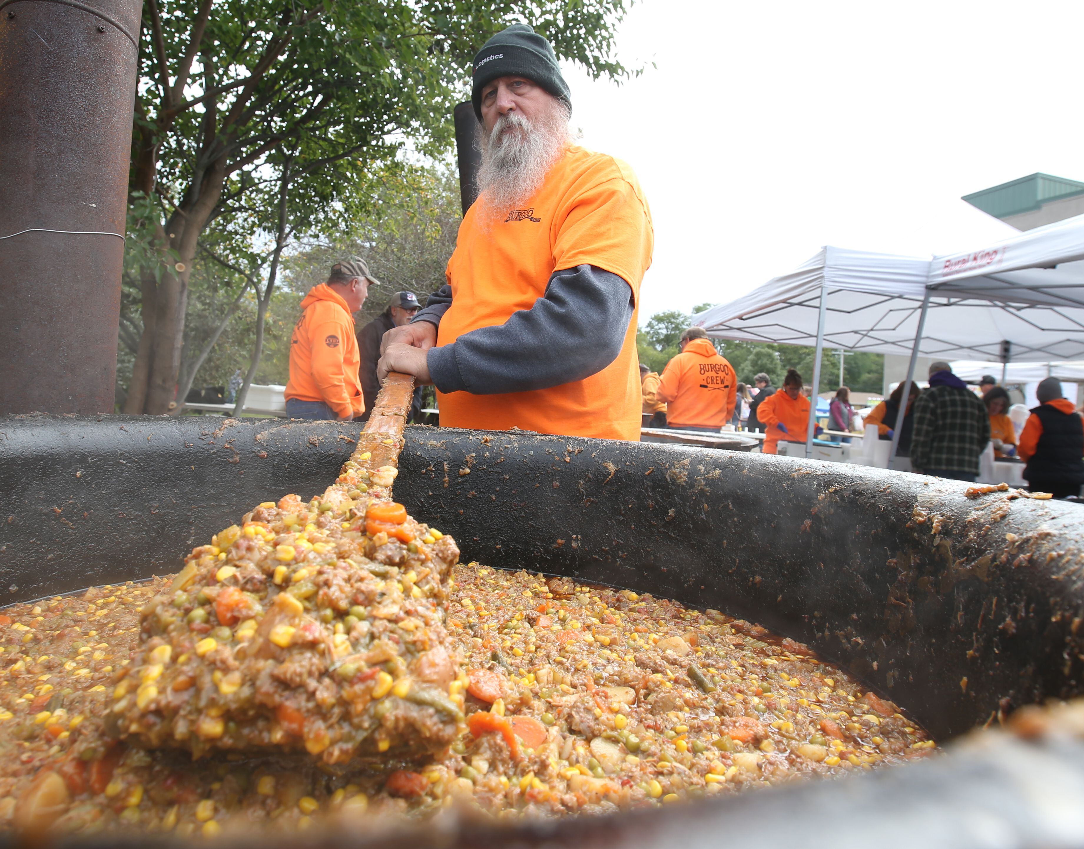 Bob Erwin of La Salle volunteers while stirring a kettle of Burgoo during the 53rd annual Burgoo on Sunday, Oct. 8, 2023 downtown Utica.