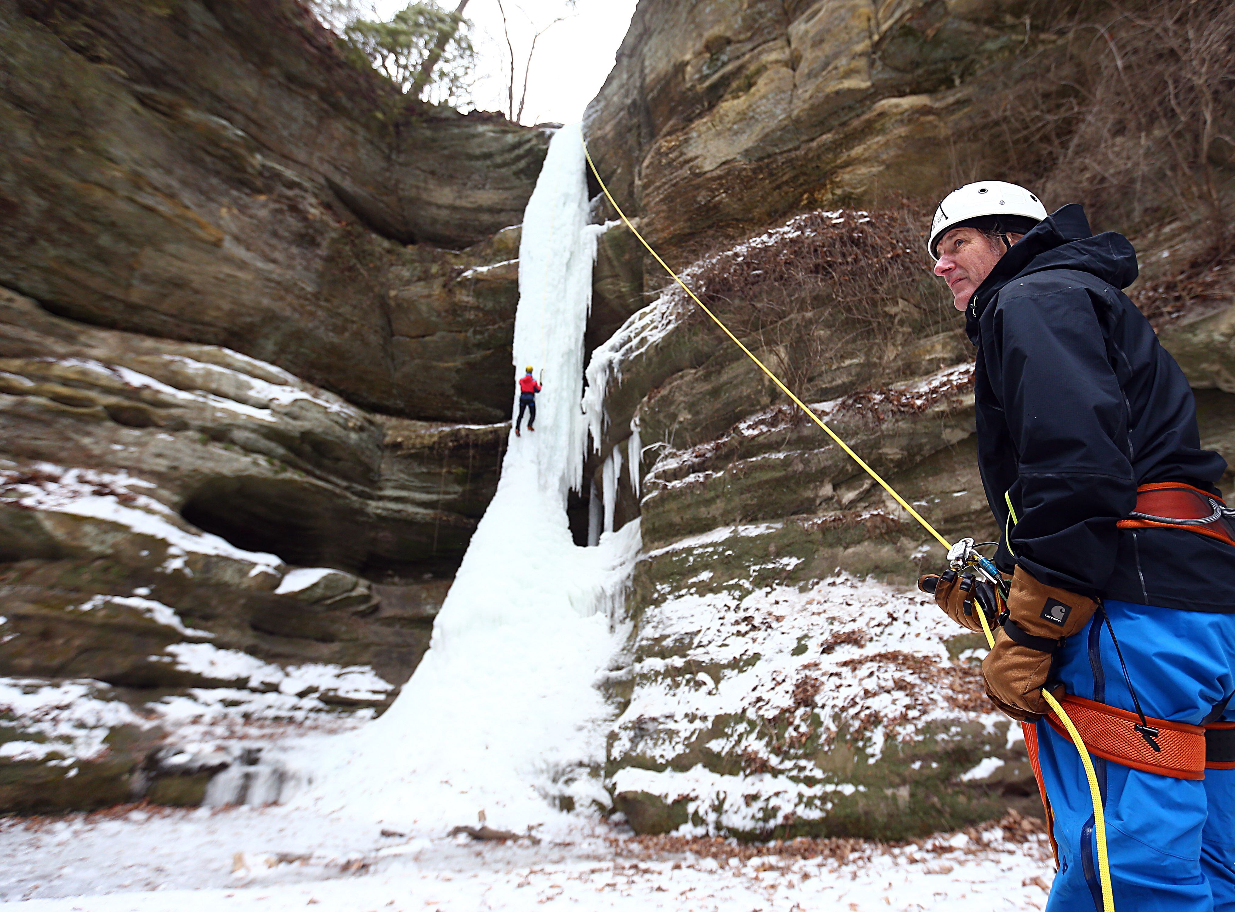 Ice climber Bruce Turner, of Chicago, holds the rope belay of ice-fall climber Dave Everson, of Homer Glen as Everson climbs up a 90 foot ice-fall at Wildcat Canyon in Starved Rock State Park on Friday Jan. 14, 2022 near Utica. 