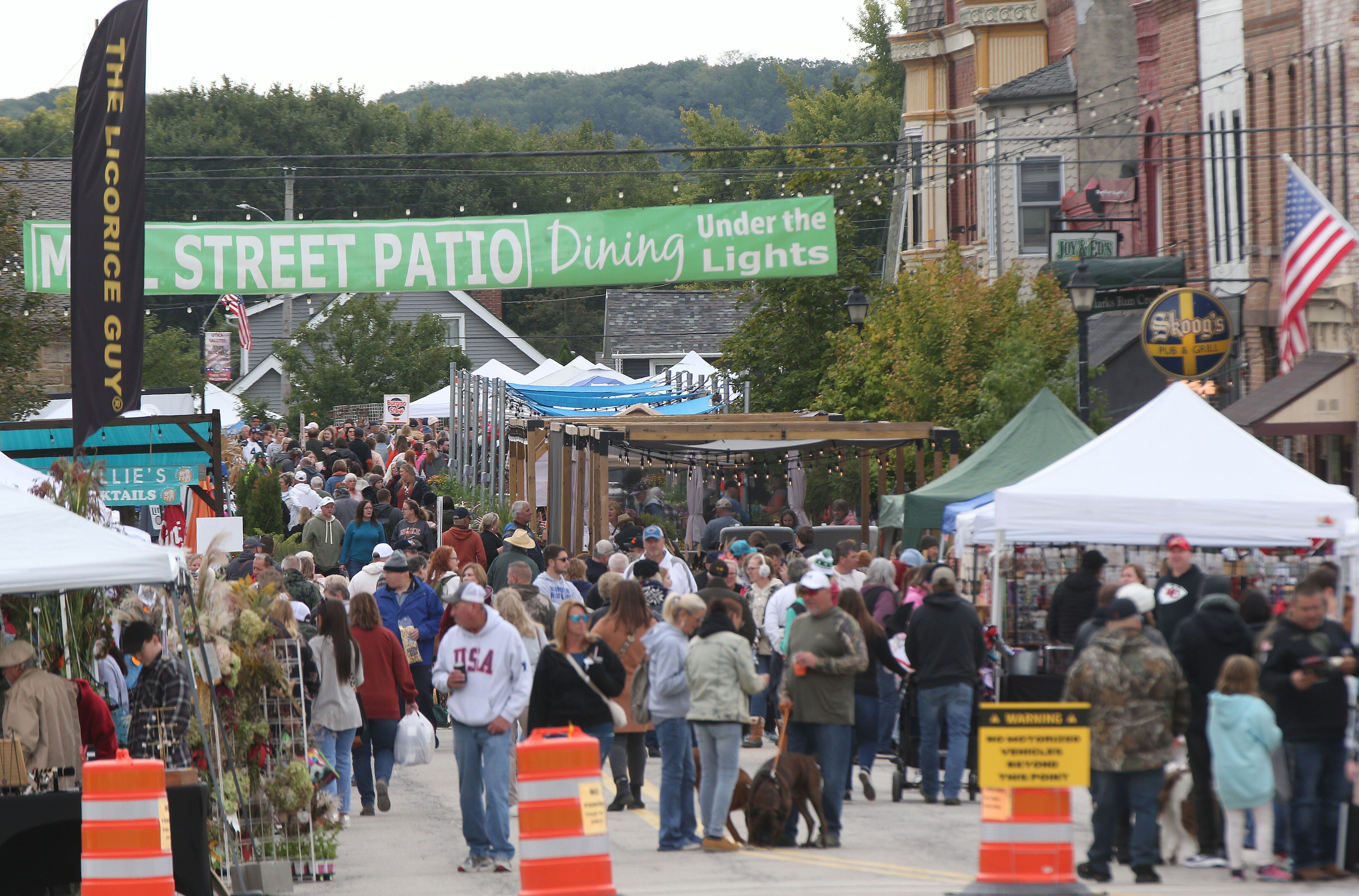 People walk down Main Street for the 53rd annual Burgoo on Sunday, Oct. 8, 2023 downtown Utica.