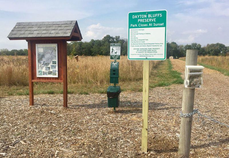 Between map displays at the Dayton Bluffs Preserve in Ottawa are a rules sign noting dogs must be leashed and a dispense for plastic bags to be used for cleaning up dog waste. Rules at Dayton Bluffs Preserve are the same as for any other city park.
