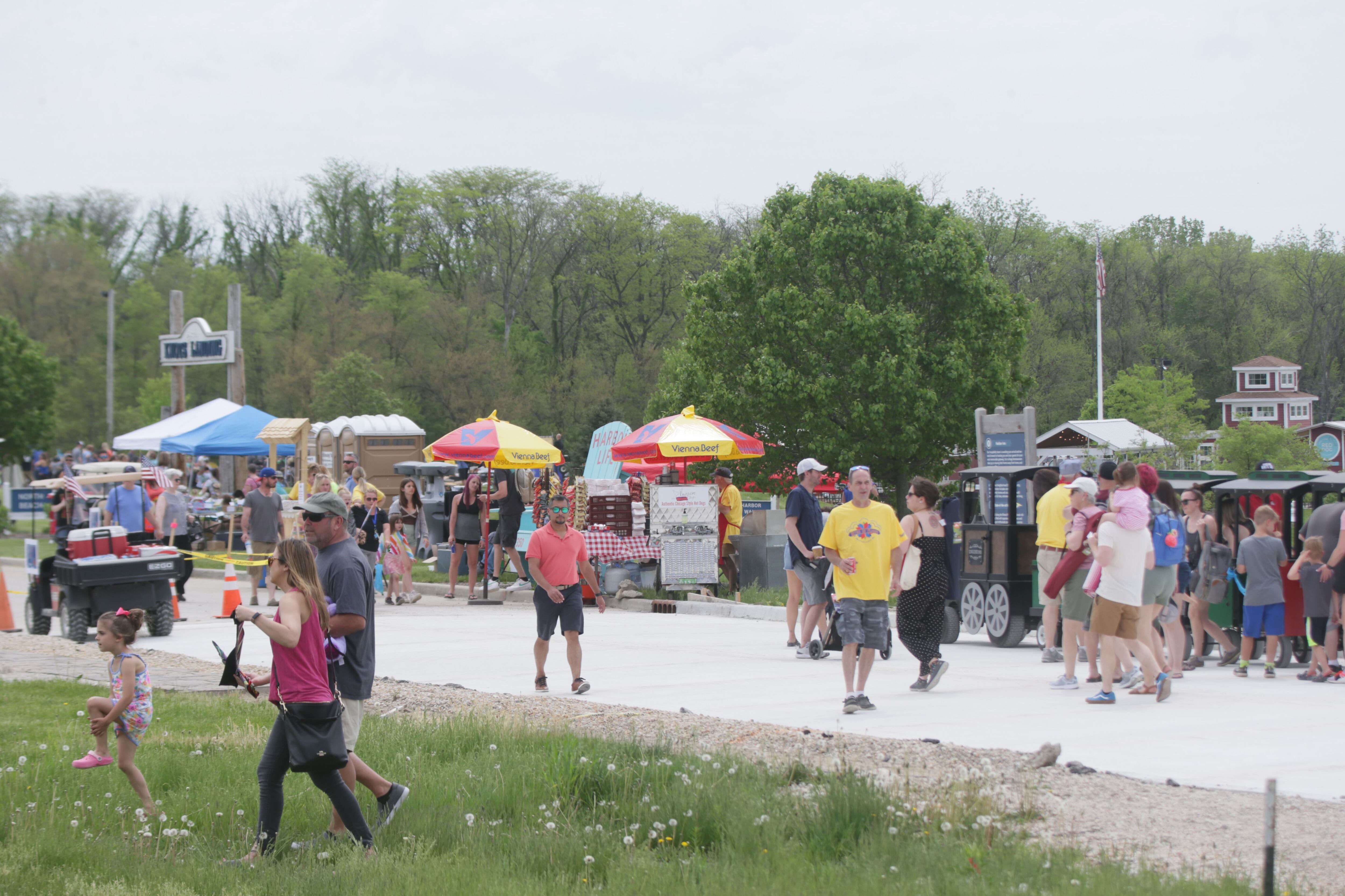 People walk through the annual 'Kites in Flight' festival on Sunday, May 15, 2022 at Heritage Harbor in Ottawa.