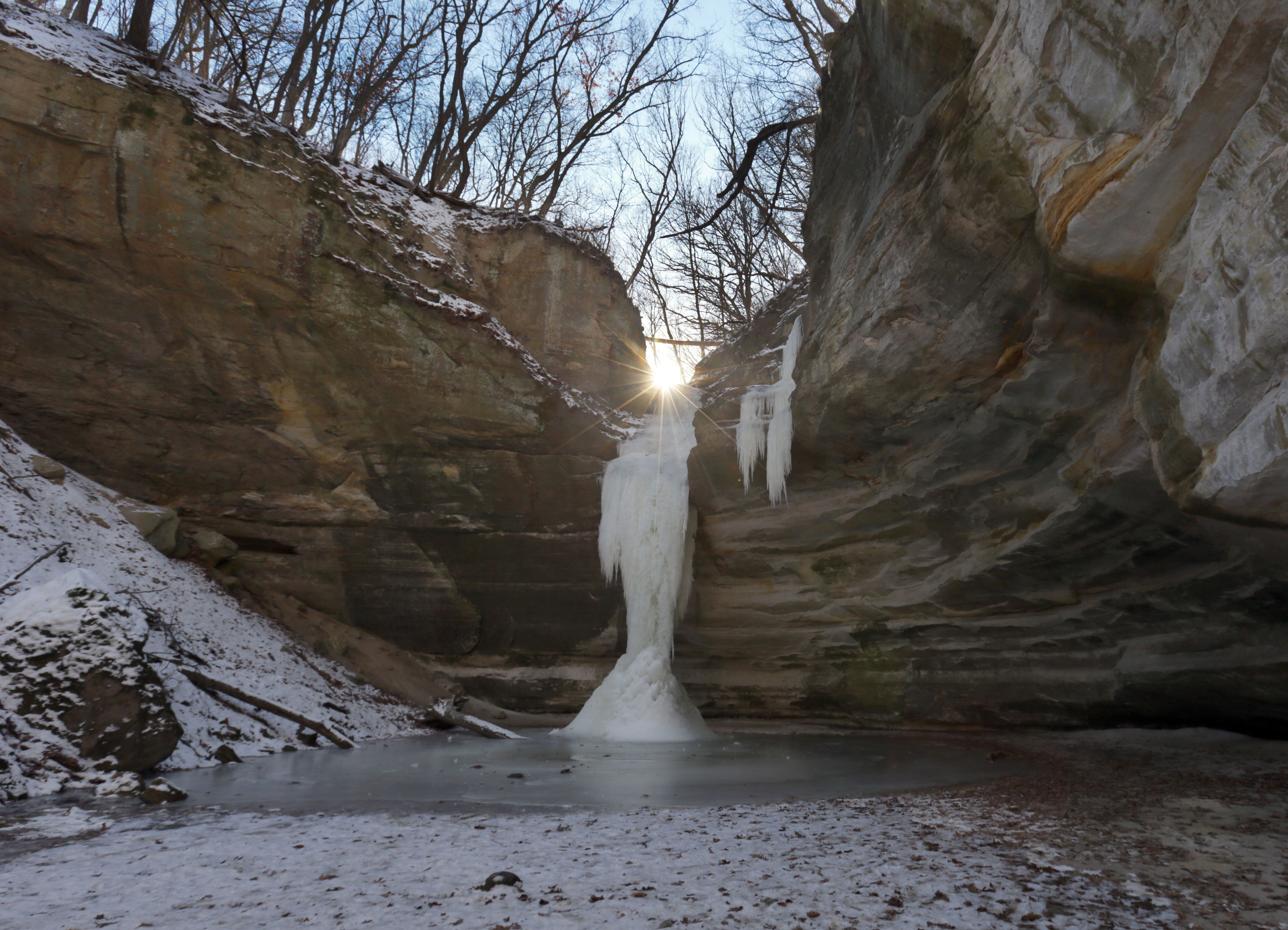 The sun shines above a frozen column waterfall in Ottawa Canyon at Starved Rock State Park on Monday Jan. 10, 2022. Icefalls are forming in nearly every canon in the park. Park staff recommends to be prepared for extremely icy staircases, trails, and canyons if you decide to visit Starved Rock and Matthiessen State Park. Proper footwear with clip ons such as Yak trax and ski poles or hiking sticks will help with balance.