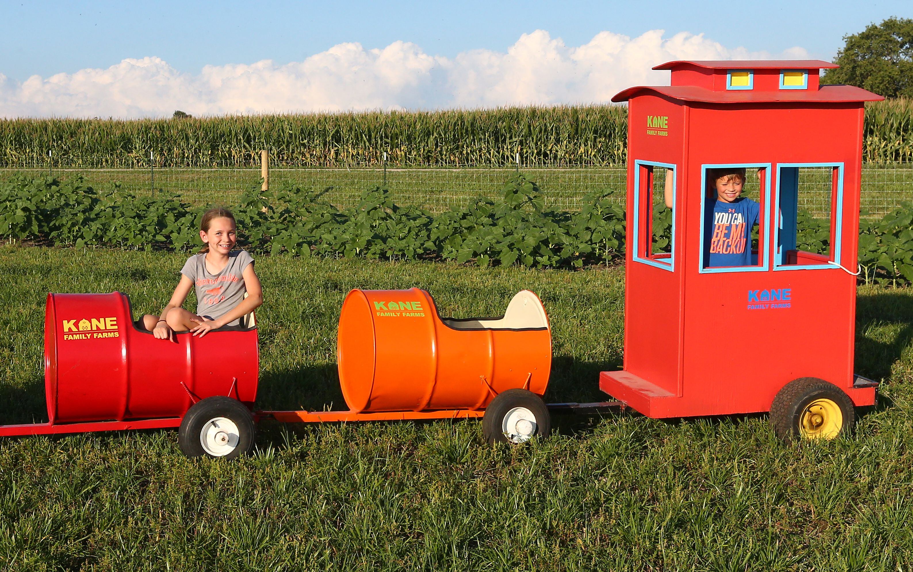 Megan Kane 11, and her brother Alex 5, ride in a barrel train at Kane Family Farms pumpkin patch on Tuesday Sept. 6, 2022 in Ottawa. 