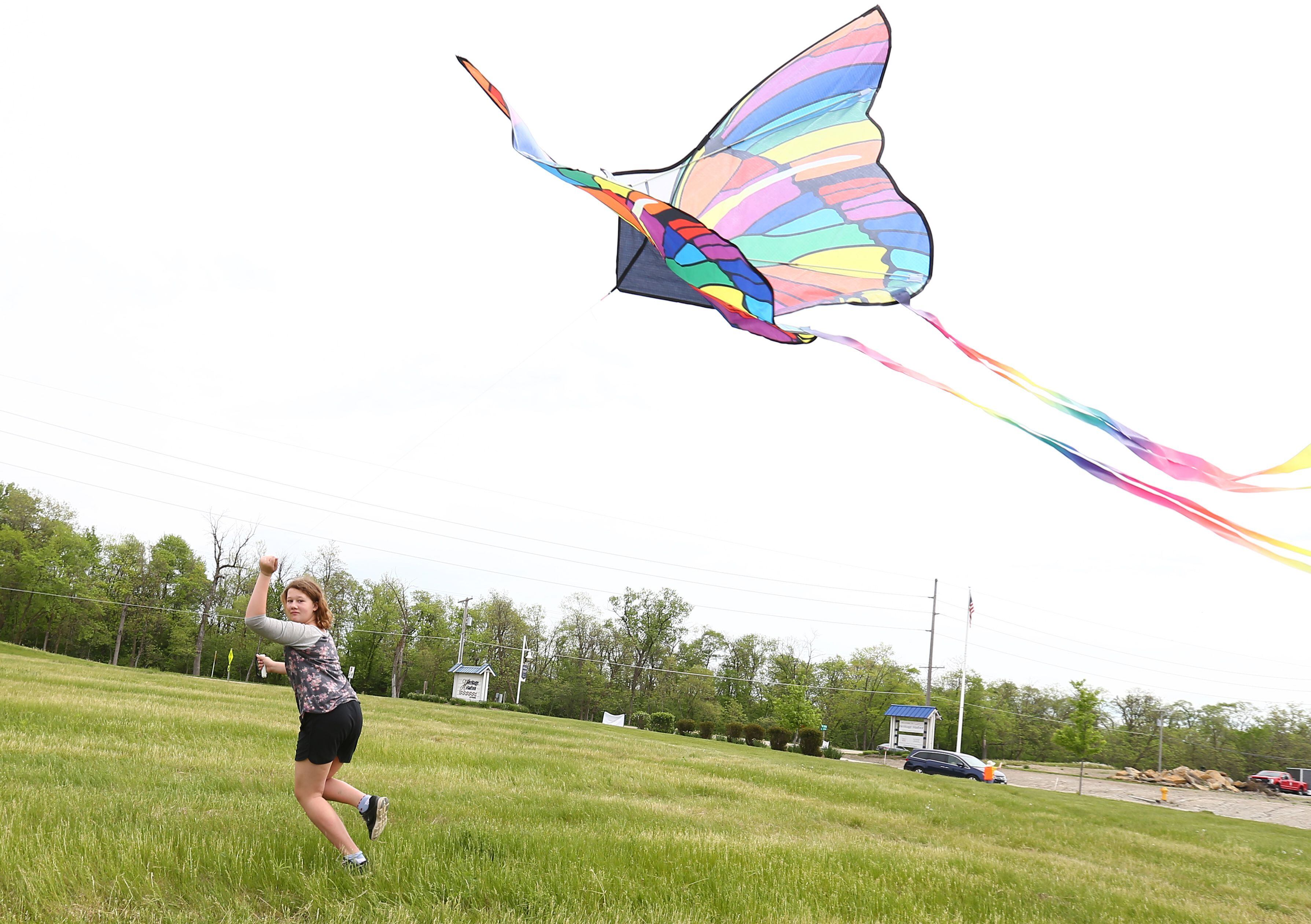 Marli Woodin of Norway runs through a large open field to fly her butterfly kite during the 'Kites in Flight' festival on Sunday, May 15, 2022 at Heritage Harbor in Ottawa.