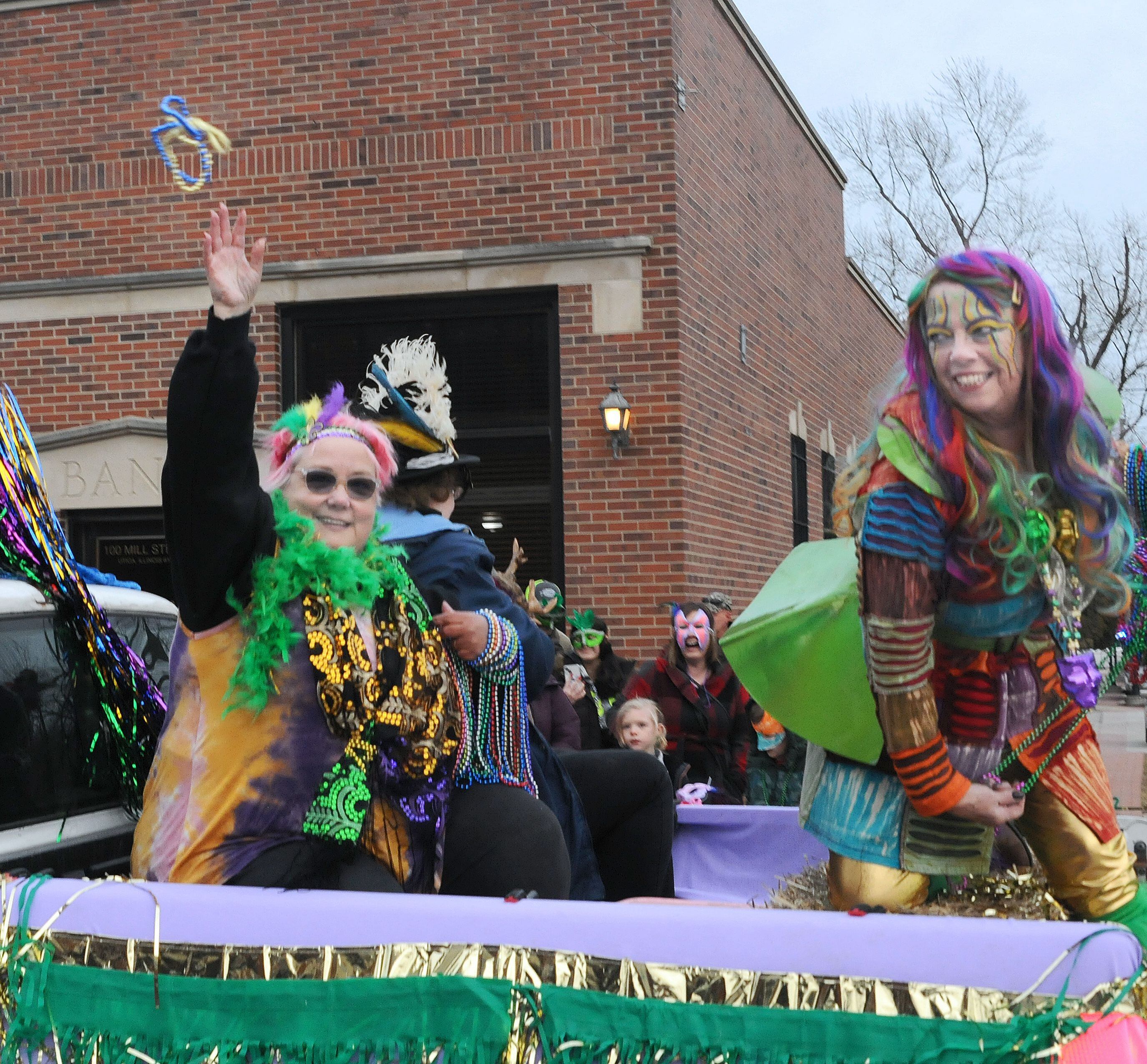 Mardi Gras revelers waited and received tokens and candy Saturday, Feb. 18, 2023, during the annual Mardi Gras parade in downtown Utica. The parade was sponsored by the Utica Business Association.