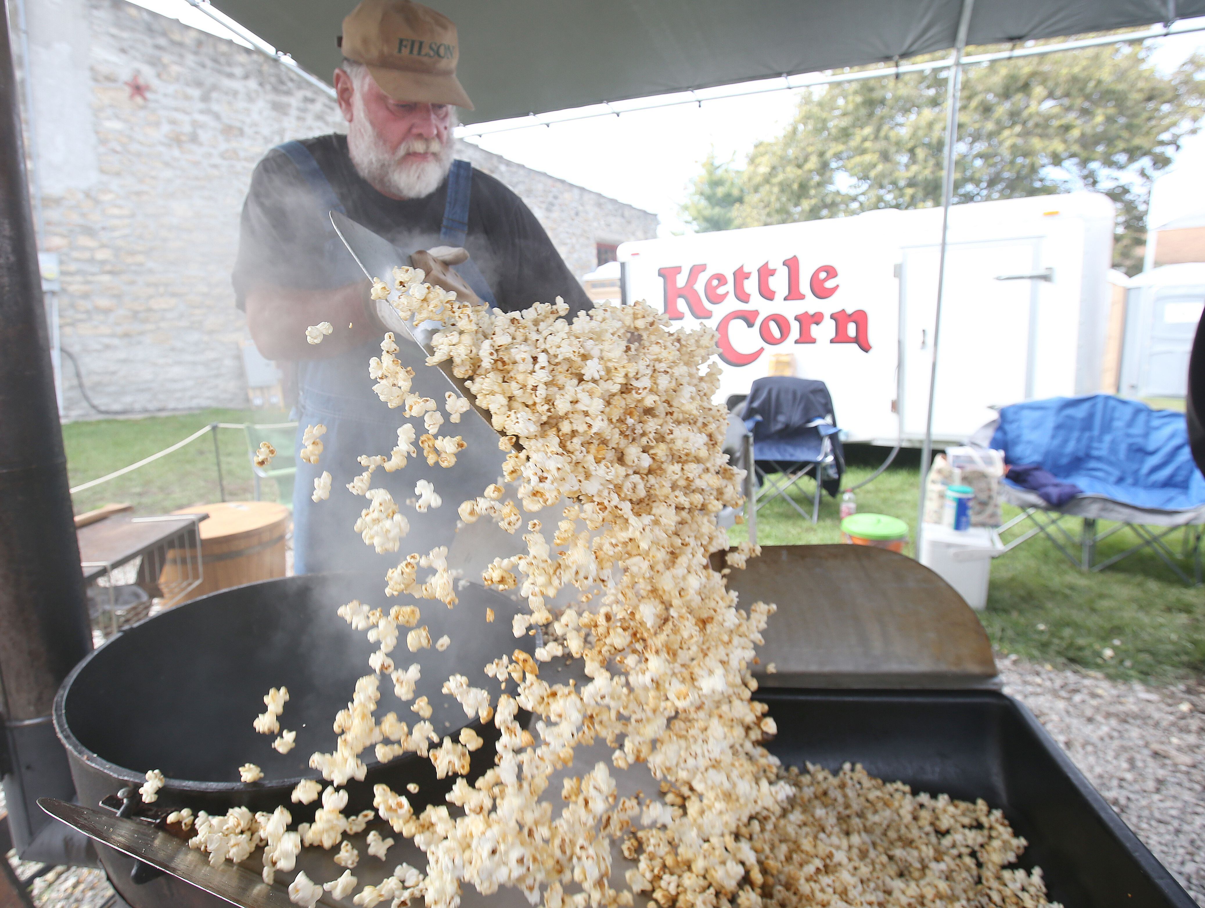 John Papineau of Ottawa, makes home made kettle corn during the 53rd annual Burgoo on Sunday, Oct. 8, 2023 downtown Utica. Papineau has been selling his kettle corn at the festival for 33 years.