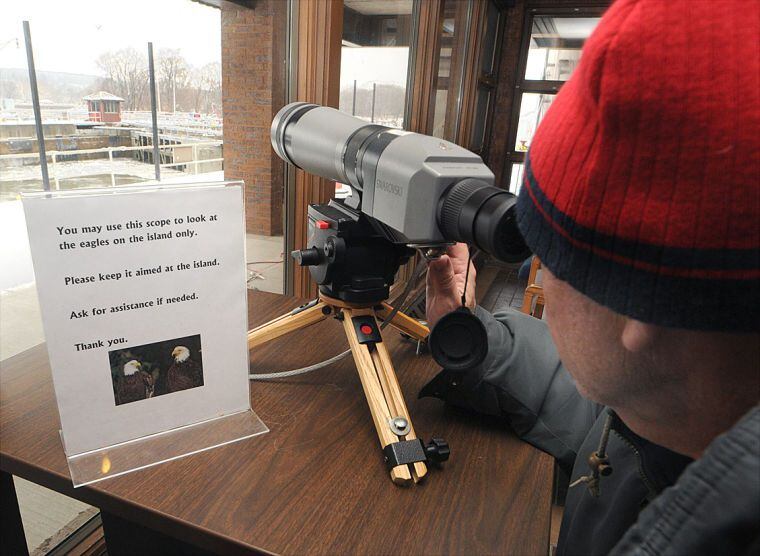 A visitor uses a spotting scope to view eagles and gulls at the Illinois Waterway Visitors Center west of Ottawa and adjacent during Eagle Watch Weekend.