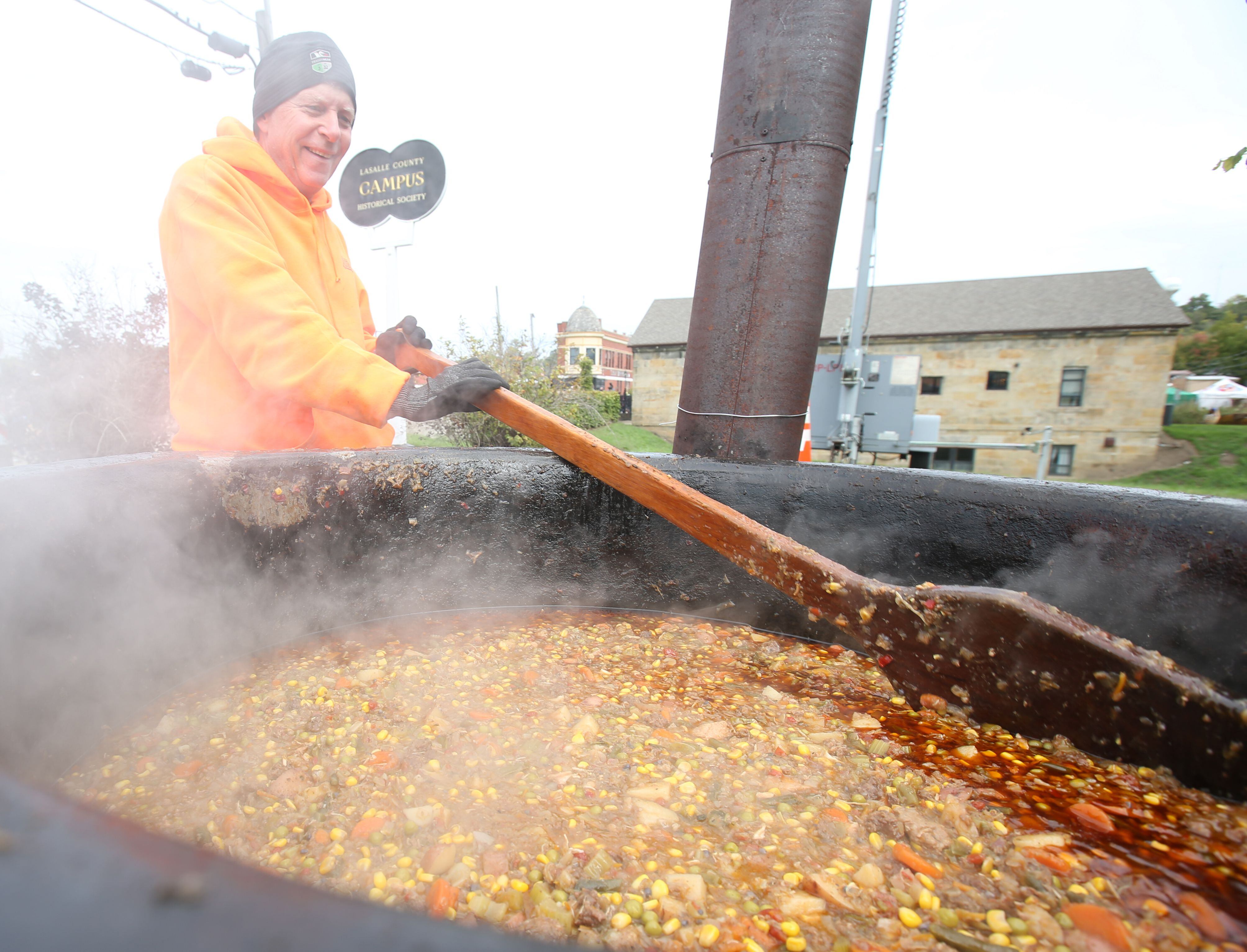 Bryon Walters of Mendota volunteers while stirring a large kettle of Burgoo during the 53rd annual Burgoo on Sunday, Oct. 8, 2023 downtown Utica.