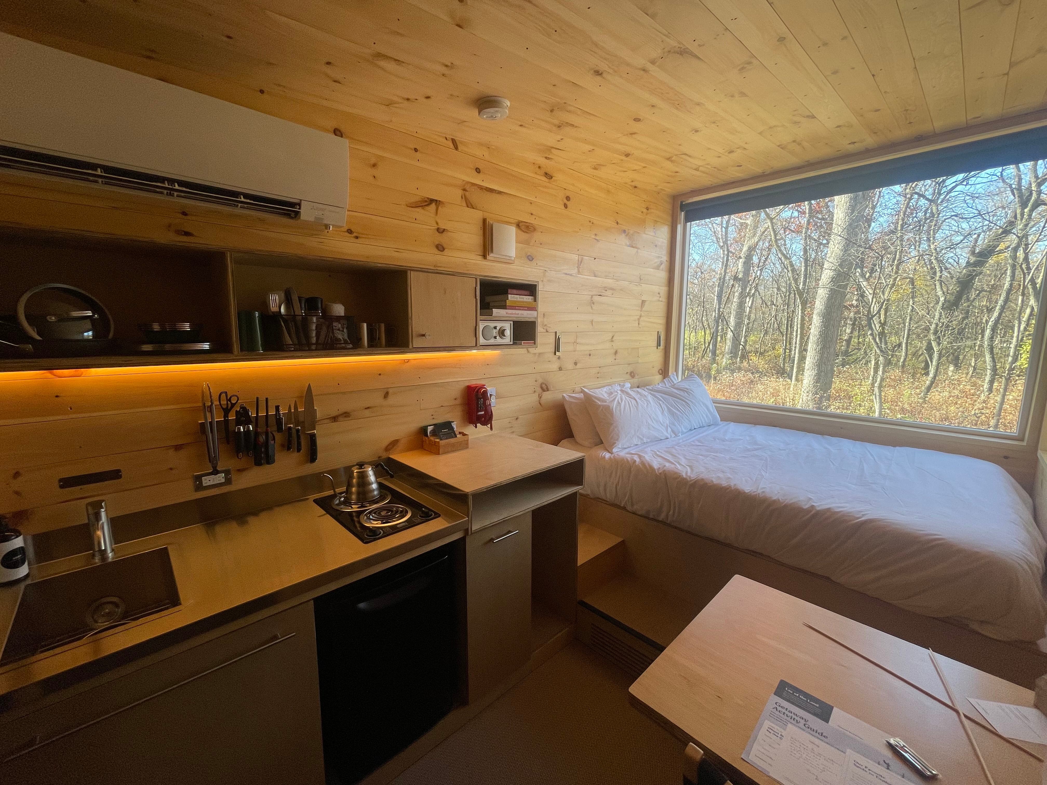 A view of the kitchen and bed inside the tiny cabin at Getaway Starved Rock on Tuesday, Nov. 1, 2022 located at 1879 N. 2703rd Road in Ottawa.